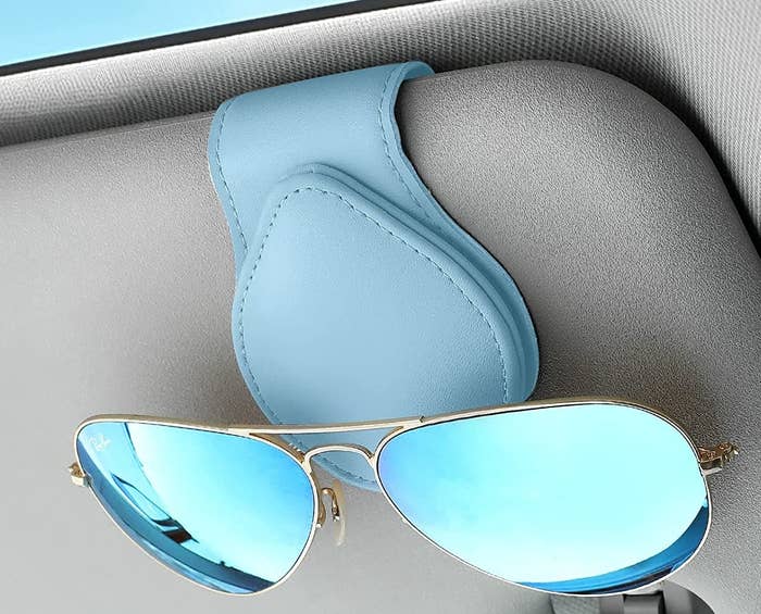 a pair of sunglasses held by the clip