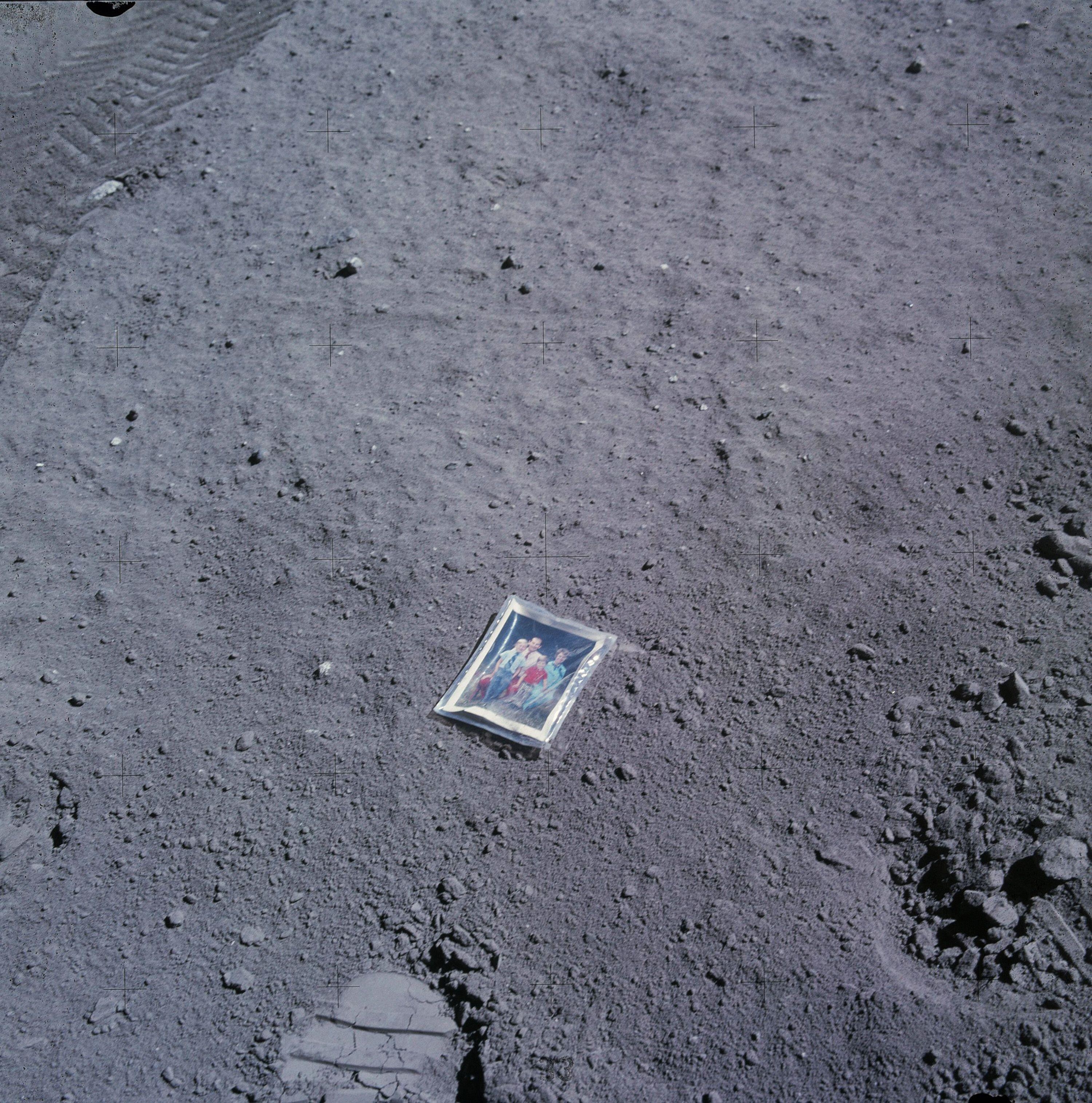 A family photo in a see-through case on the ground