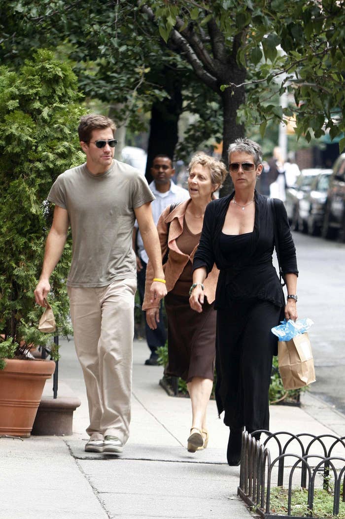 Jake Gyllenhaal and Jamie Lee Curtis walking side-by-side down a sidewalk