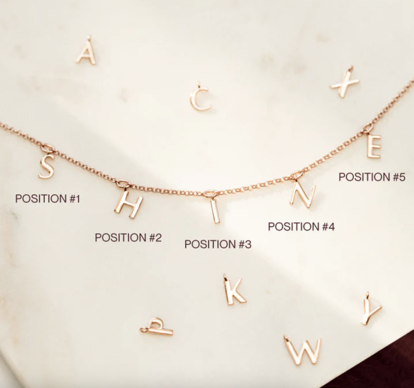 a necklace with letters that spell shine