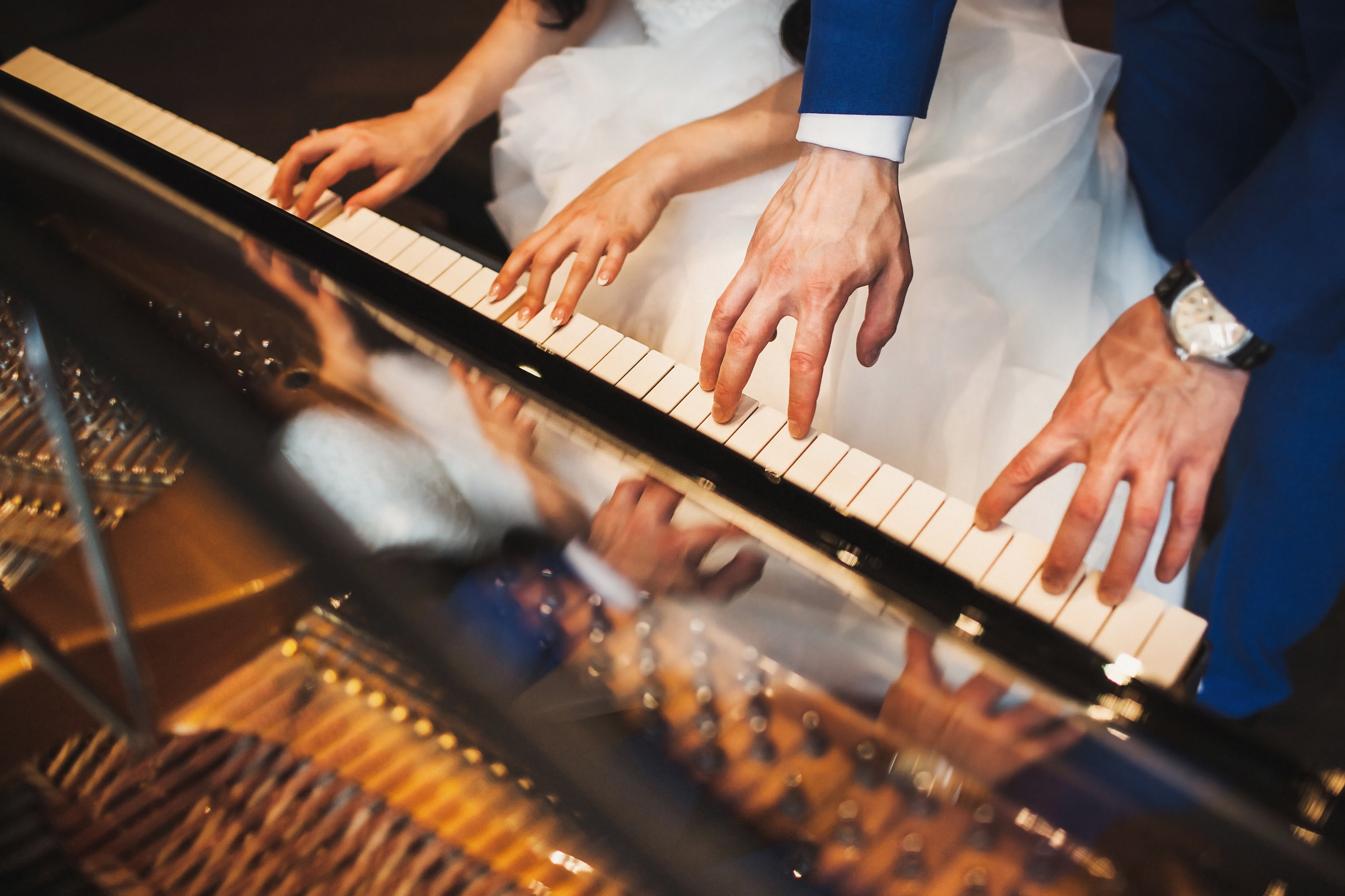 bride and groom playing the piano