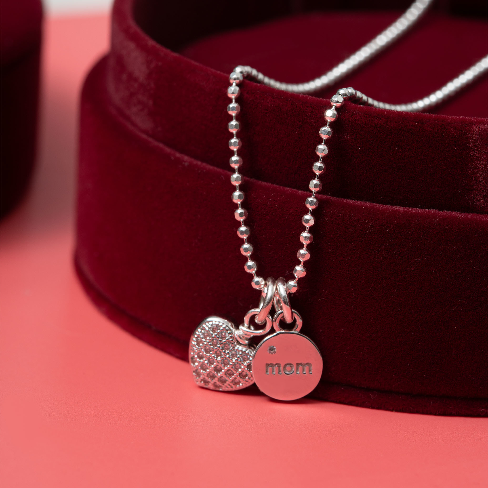 a necklace with mom and a heart charms