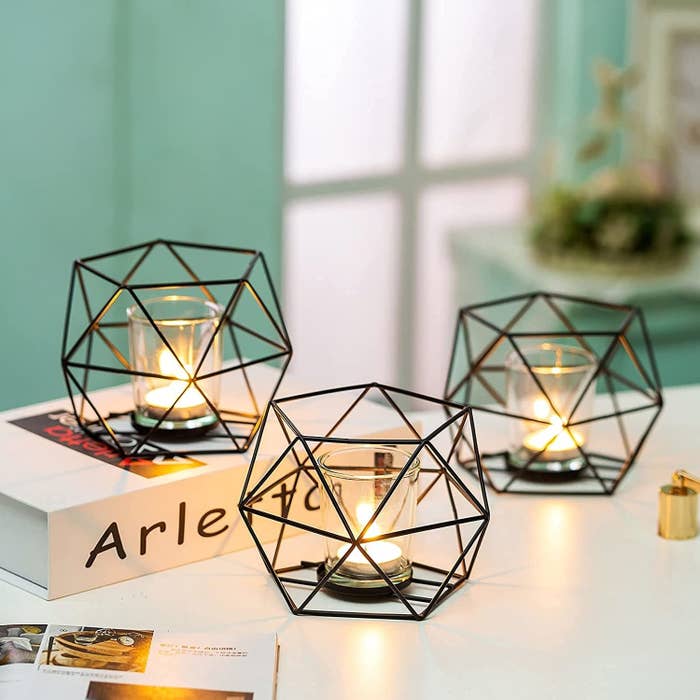A set of three geometric candle holders