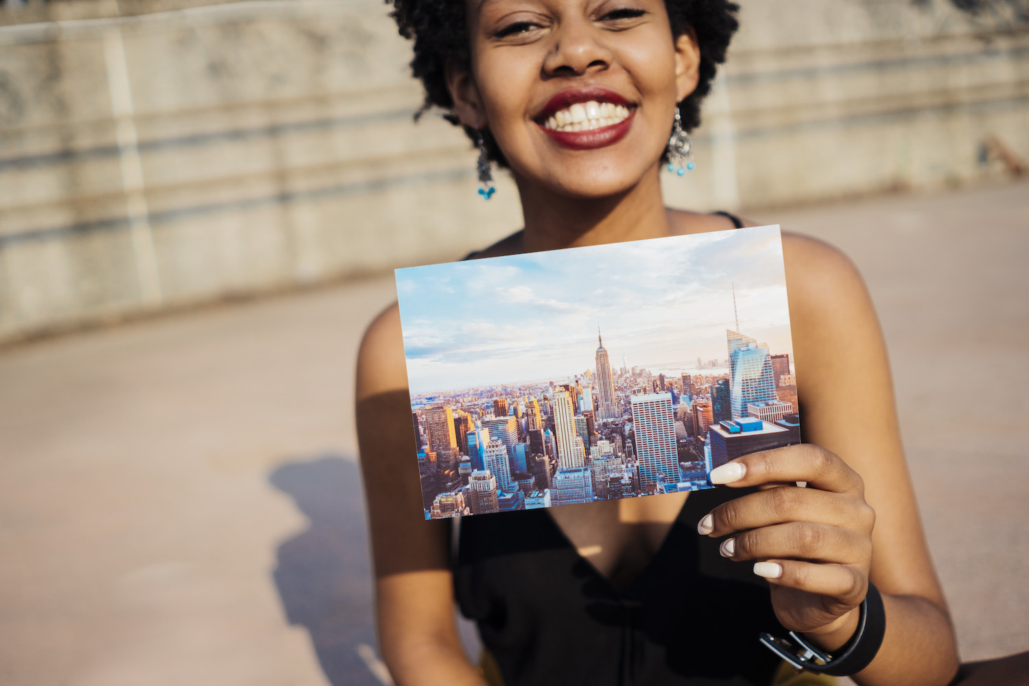 A woman holding a postcard