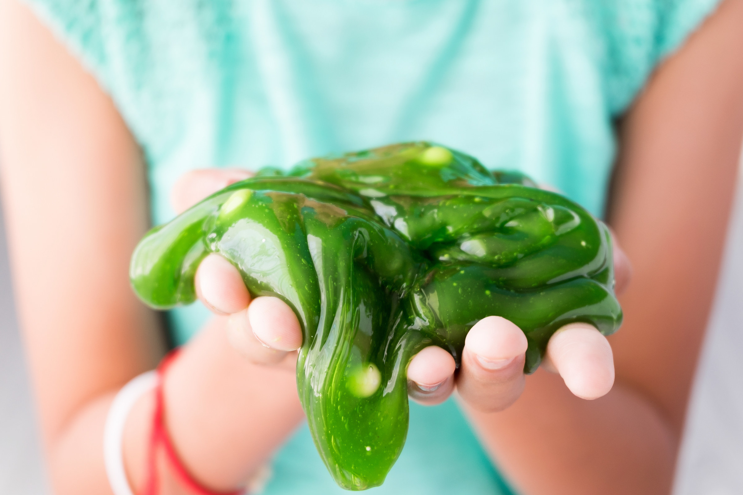 A kid playing with slime