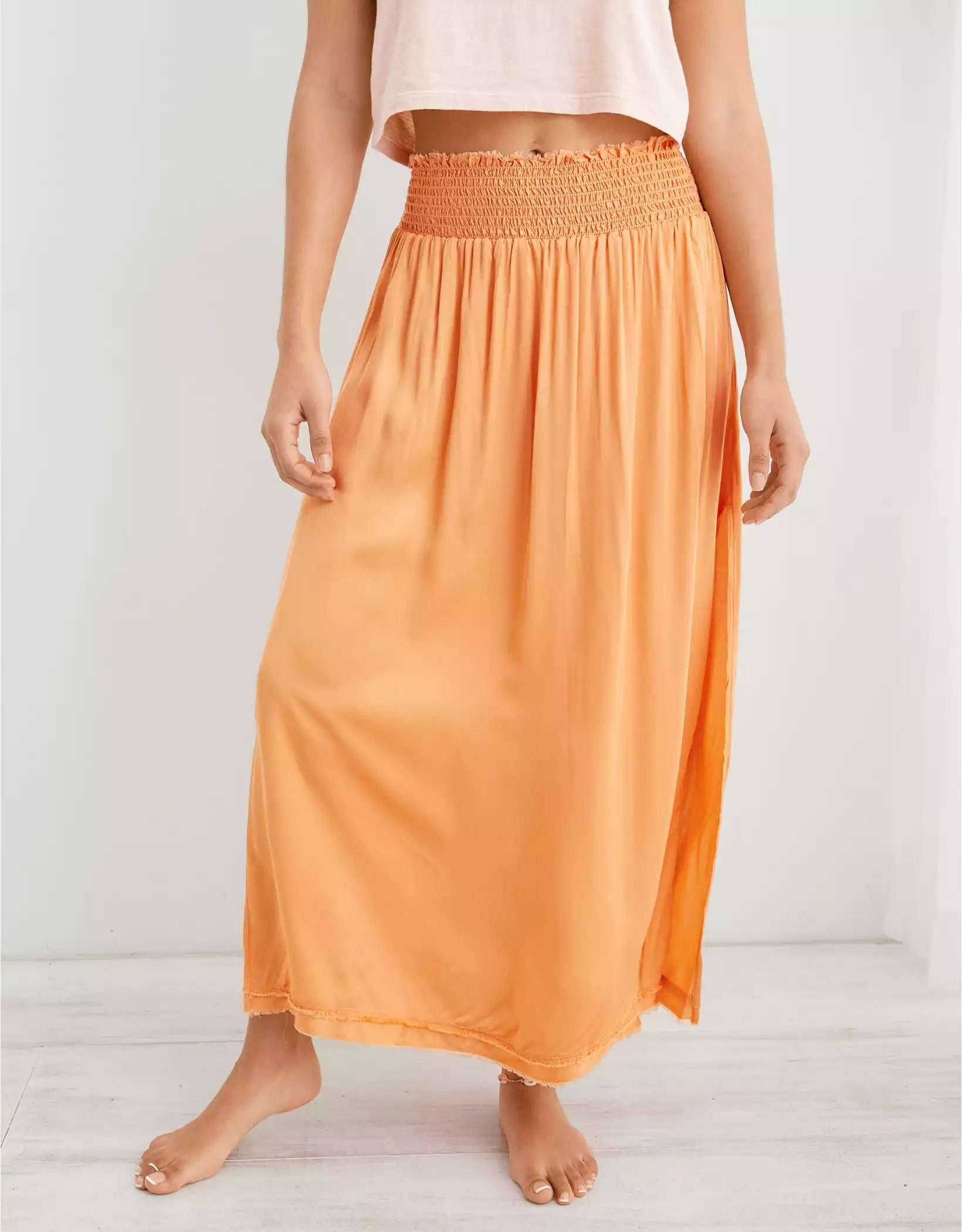 Model wearing orange midi skirt
