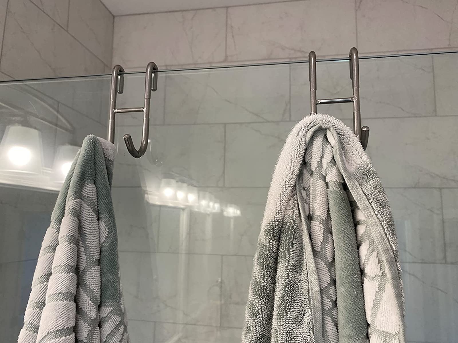 Reviewer image of two silver hooks holding towels