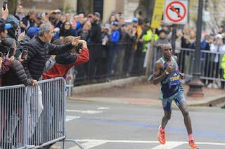 Evans Chebet rounds one of the final corners en route to his second straight Boston Marathon victory.