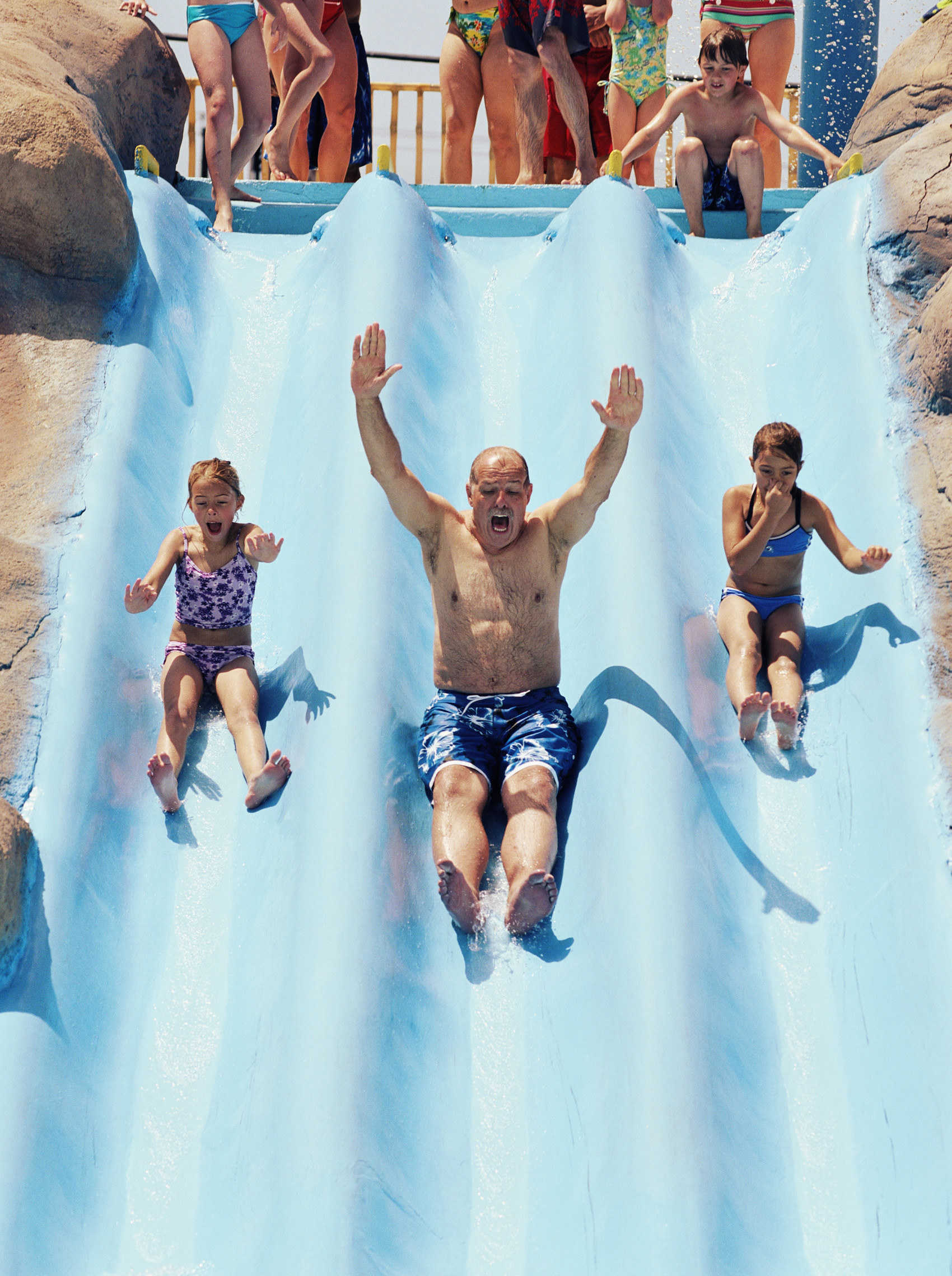 A family going down the water slide