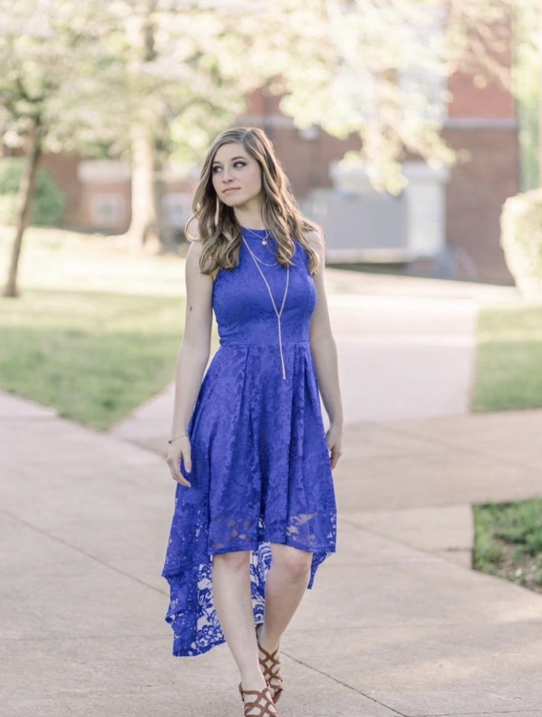 person walking on a sidewalk with the lace dress on