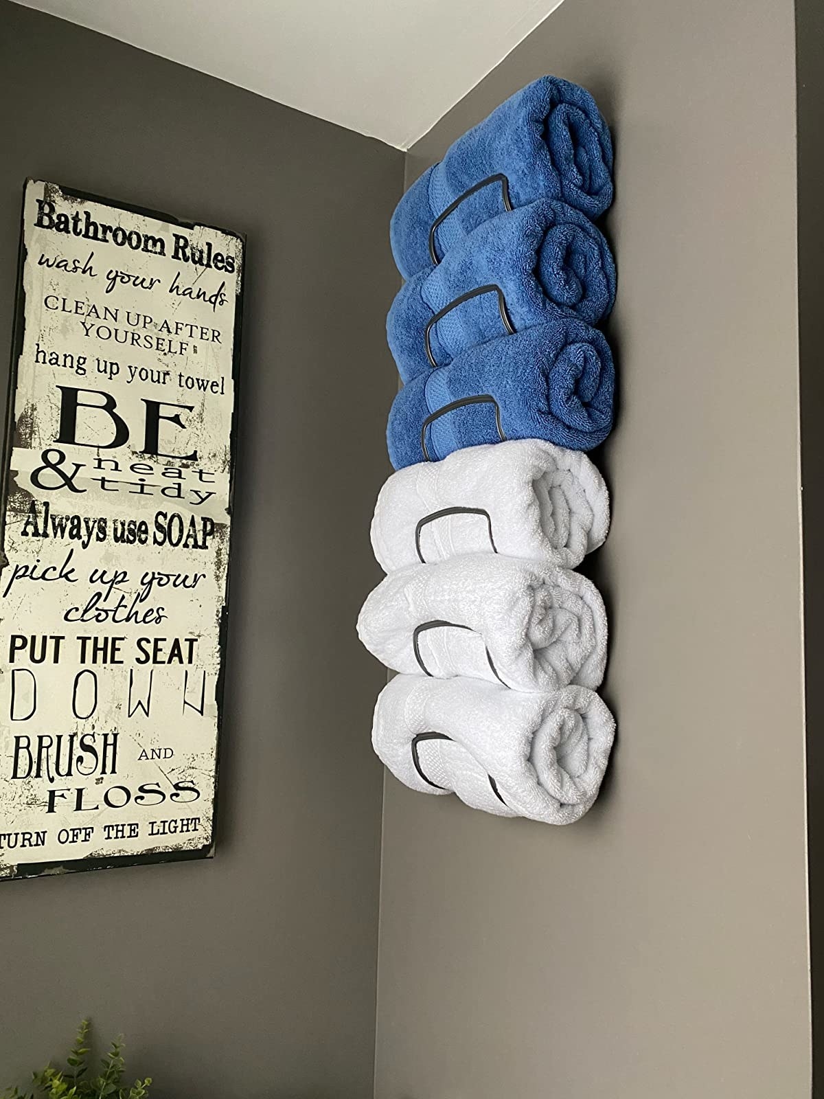 Reviewer image of white and blue rolled towels stored in their bathroom