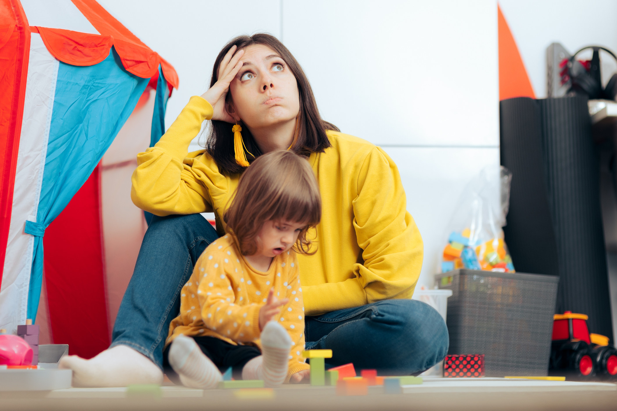 Woman stressed while playing with daughter
