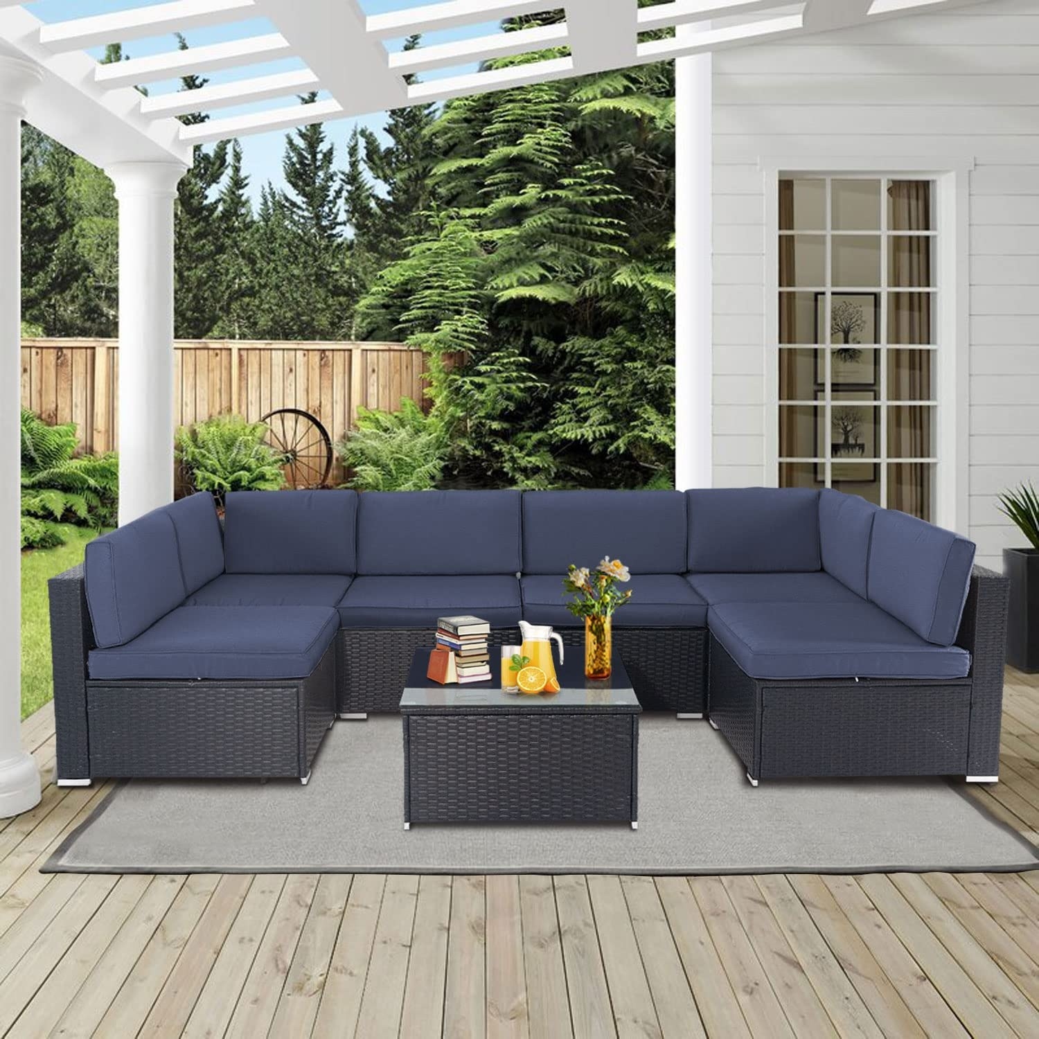 An outdoor sectional and matching coffee table are shown on a deck