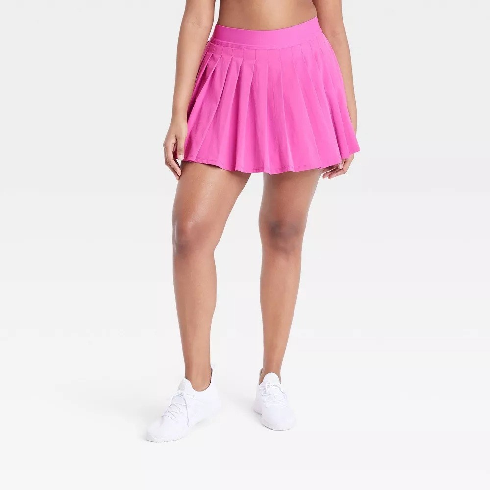 model wearing pink pleated skort