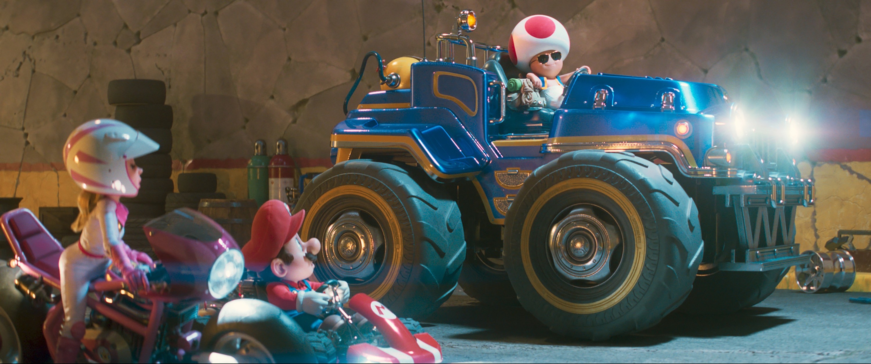 Mario, Princess Peach, and Toad lined up at the start of the Mario Kart racing scene