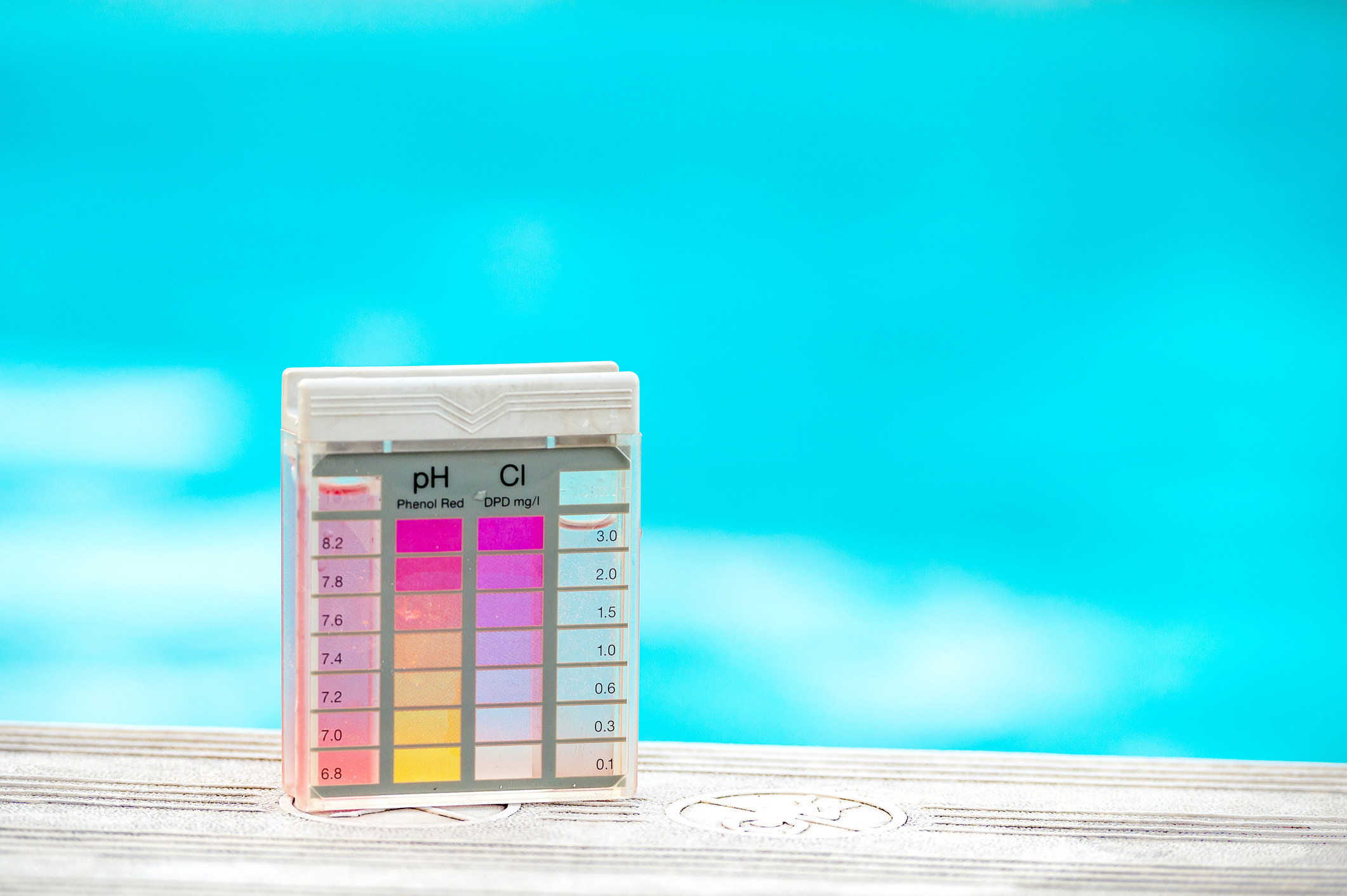 A stock image photo of an alkaline testing system sitting by a pool of water
