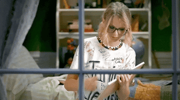 Taylor Swift holding up a sign that says &quot;you ok?&quot;