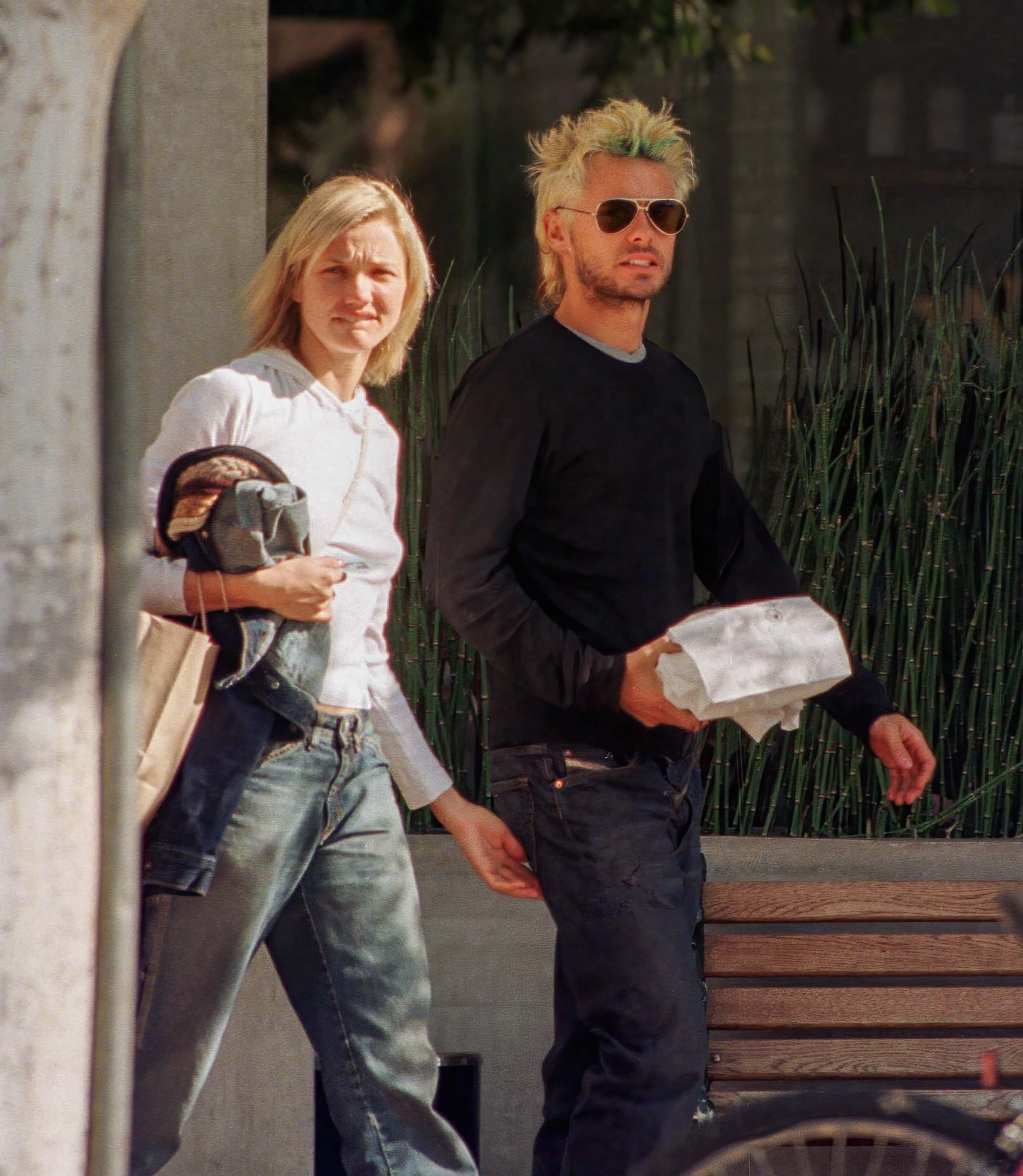 A paparazzi photo of Cameron Diaz and Jared Leto, clearly from the 2000s based on their baggy jeans and bleached hair, walking down the street together