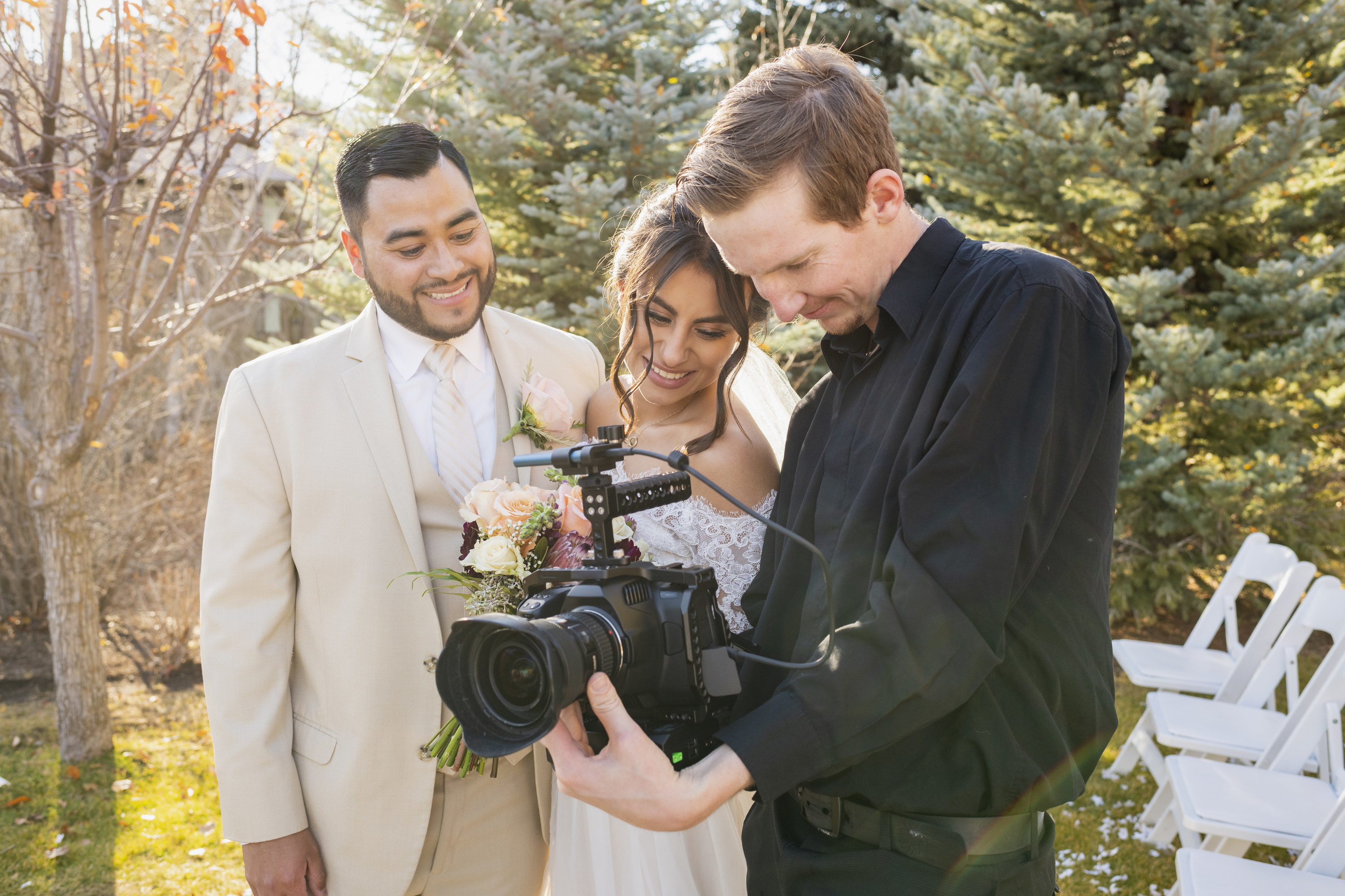 couple looking at photos with their wedding photographer
