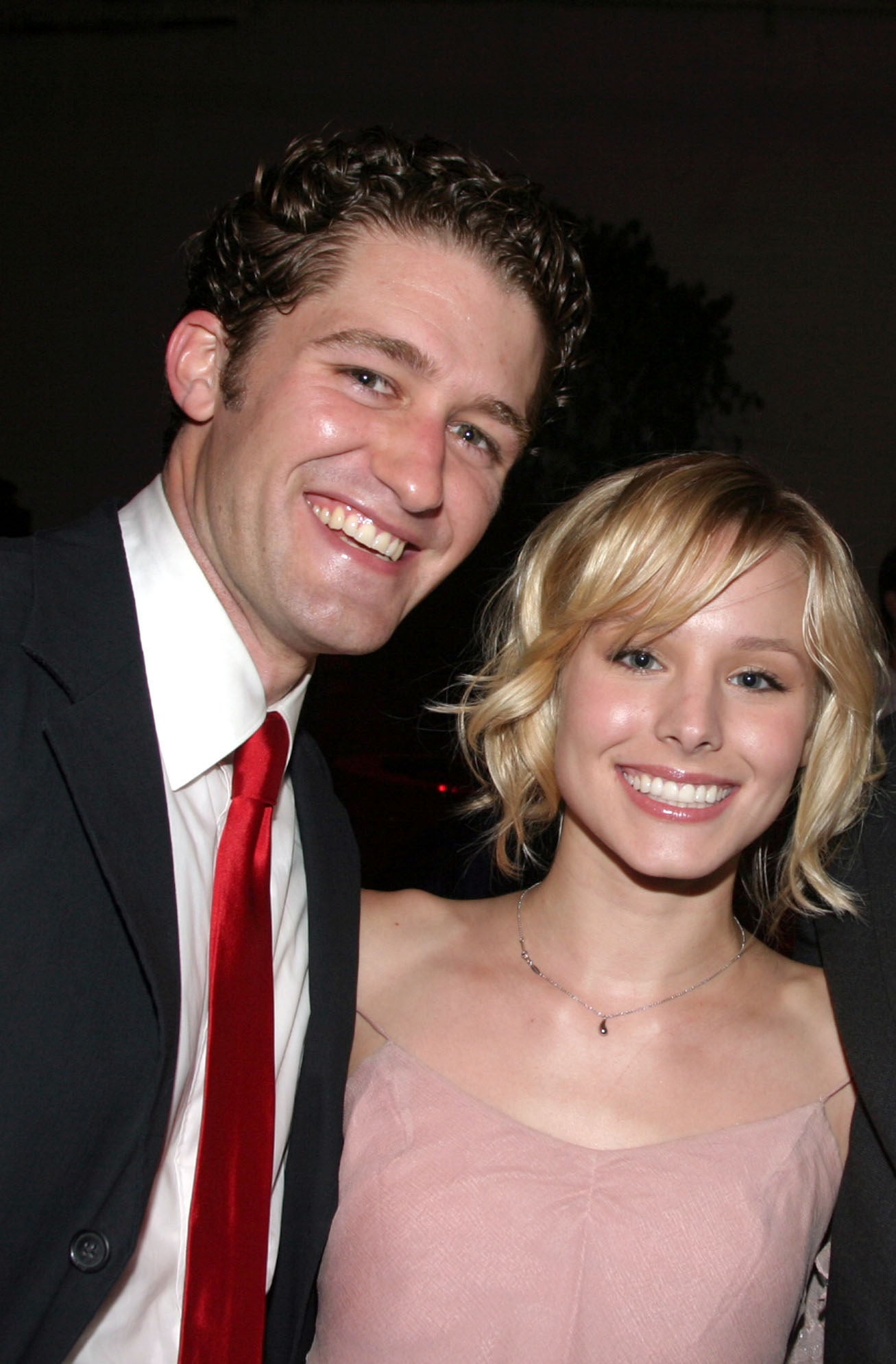 A photo of a young Matthew Morrison and Kristen Bell posing together at an event