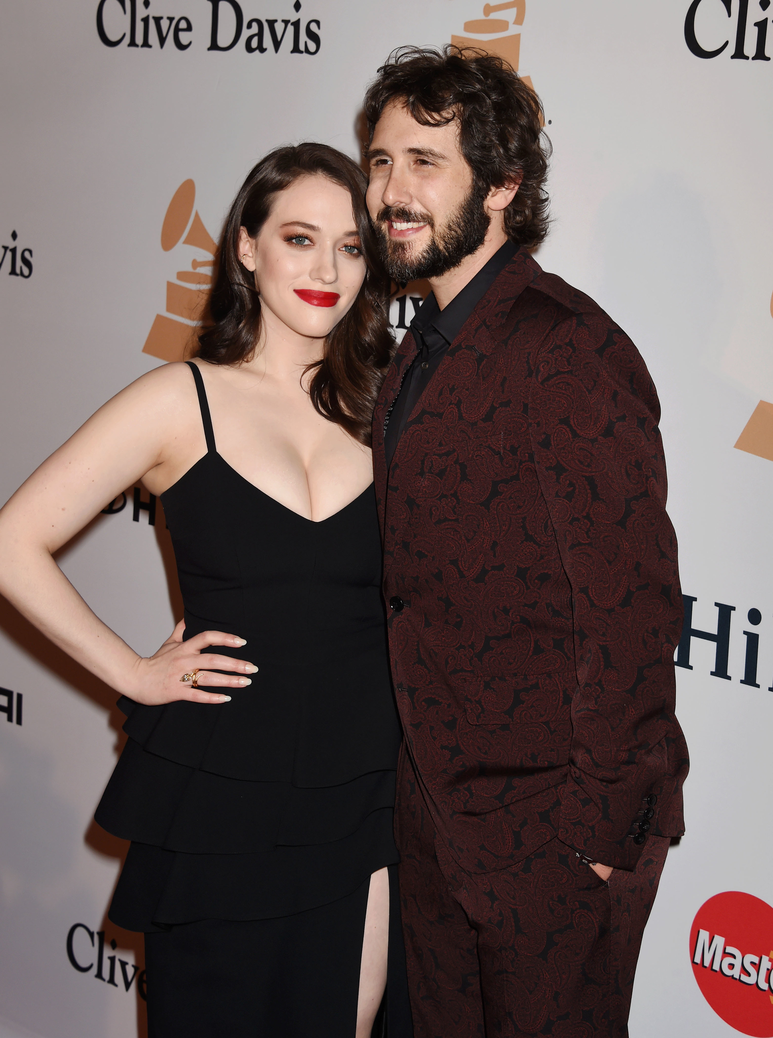 Kat Dennings and Josh Groban posing arm-in-arm on the red carpet in formalwear