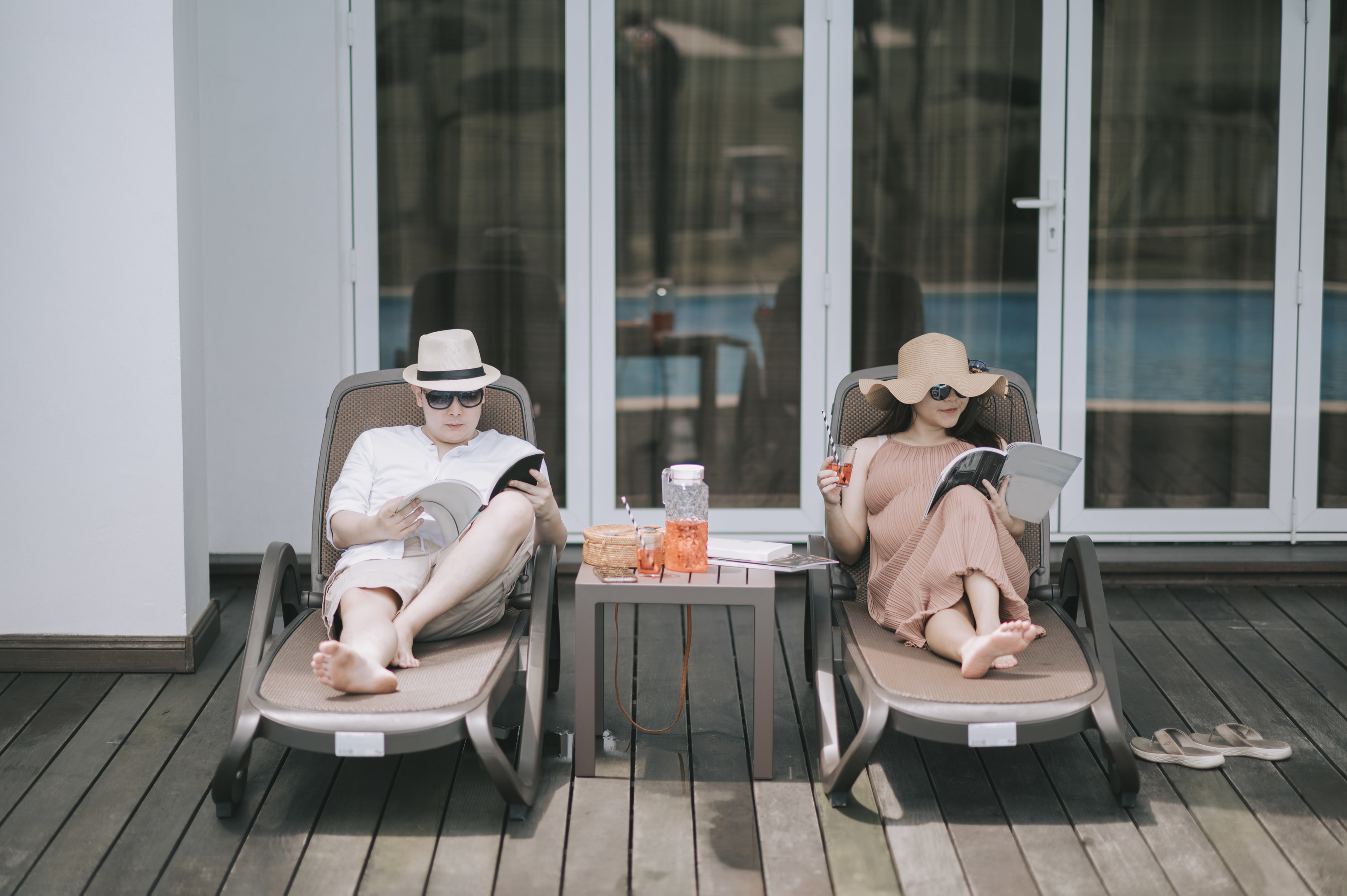 couple lounging with drinks on vacation