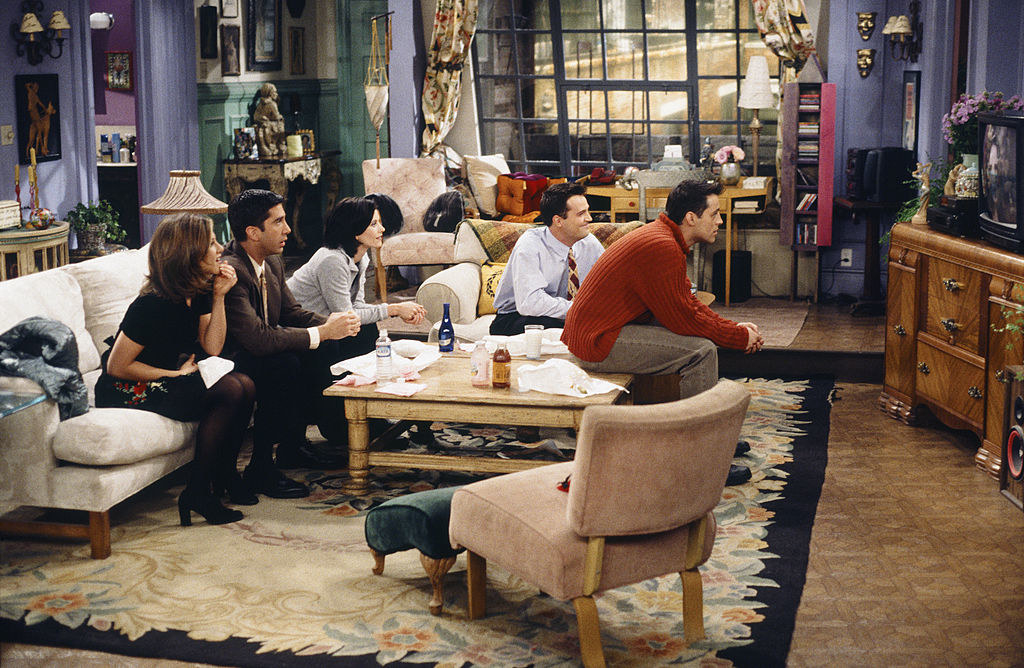 The cast of Friends sitting together and watching TV