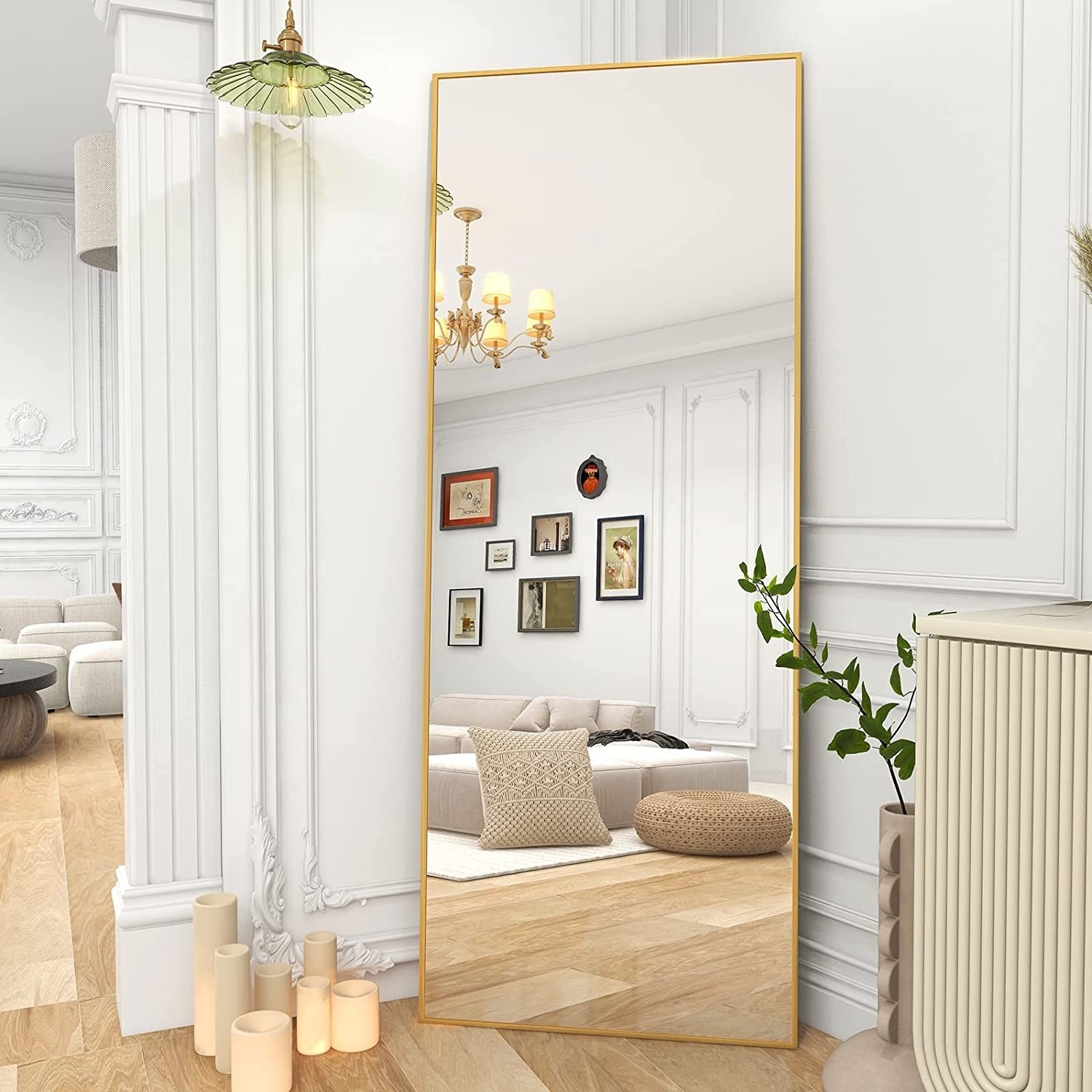 the gold rectangular mirror leaning against a wall