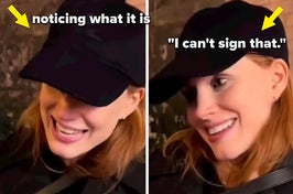 Jessica Chastain smiles as a fan approaches her to ask for an autograph