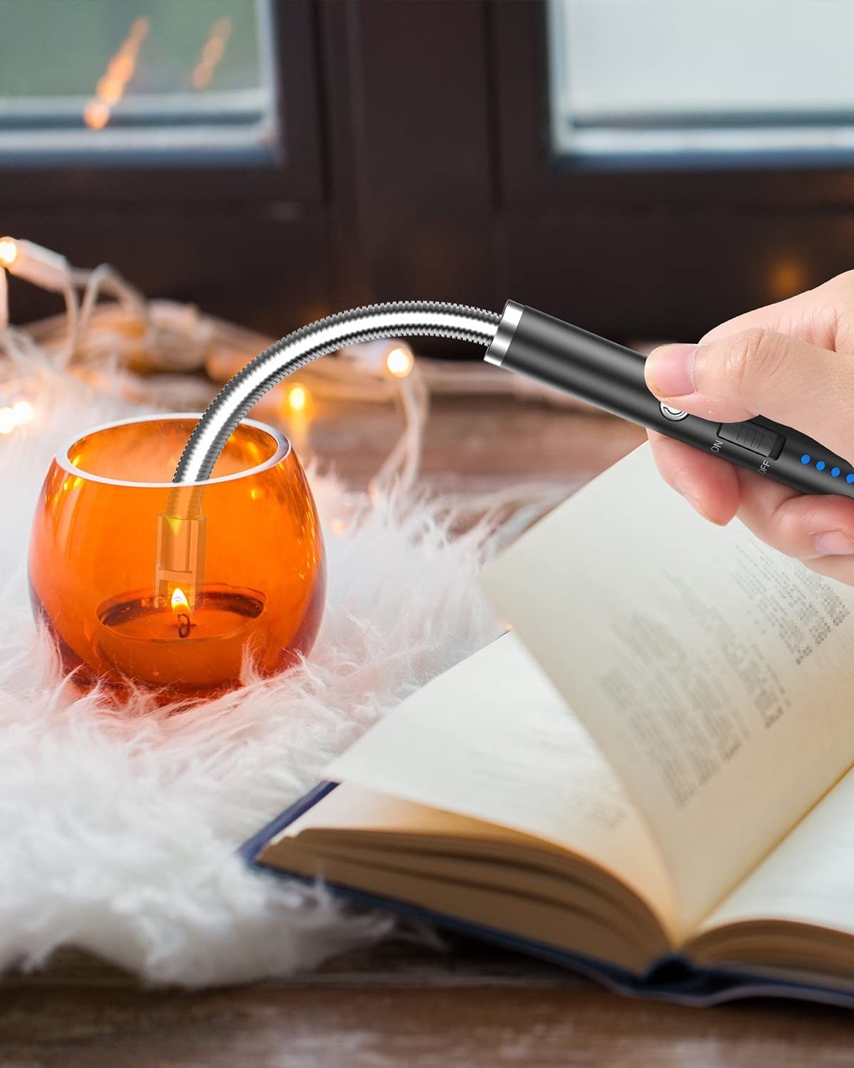 a hand using the lighter on a candle