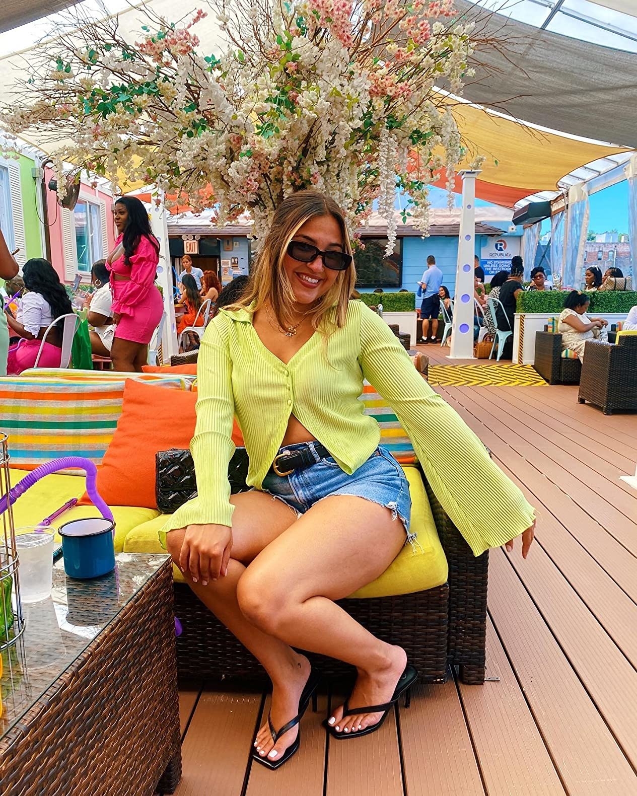 Reviewer wearing bell sleeve blouse in yellow-green