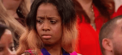 a woman in the crowd looks confused