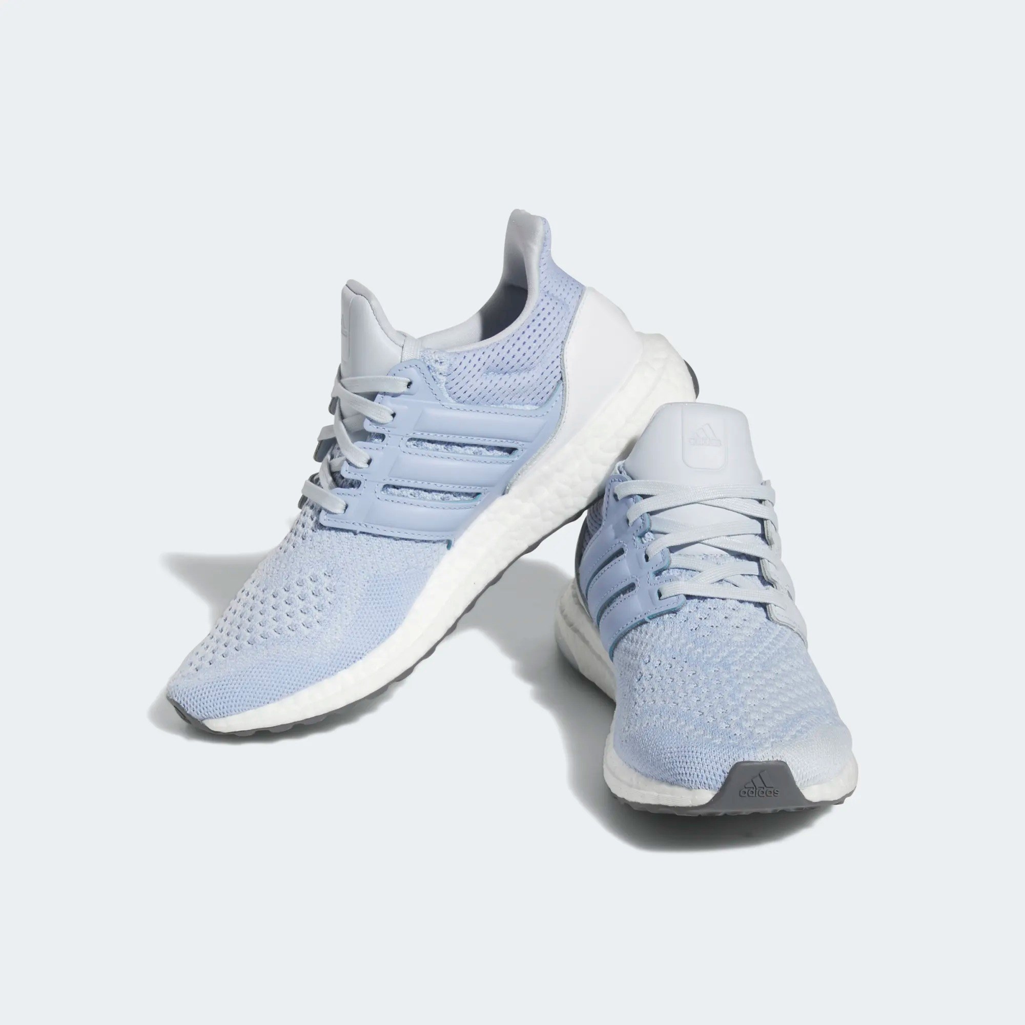 a pair of light blue adidas sneakers