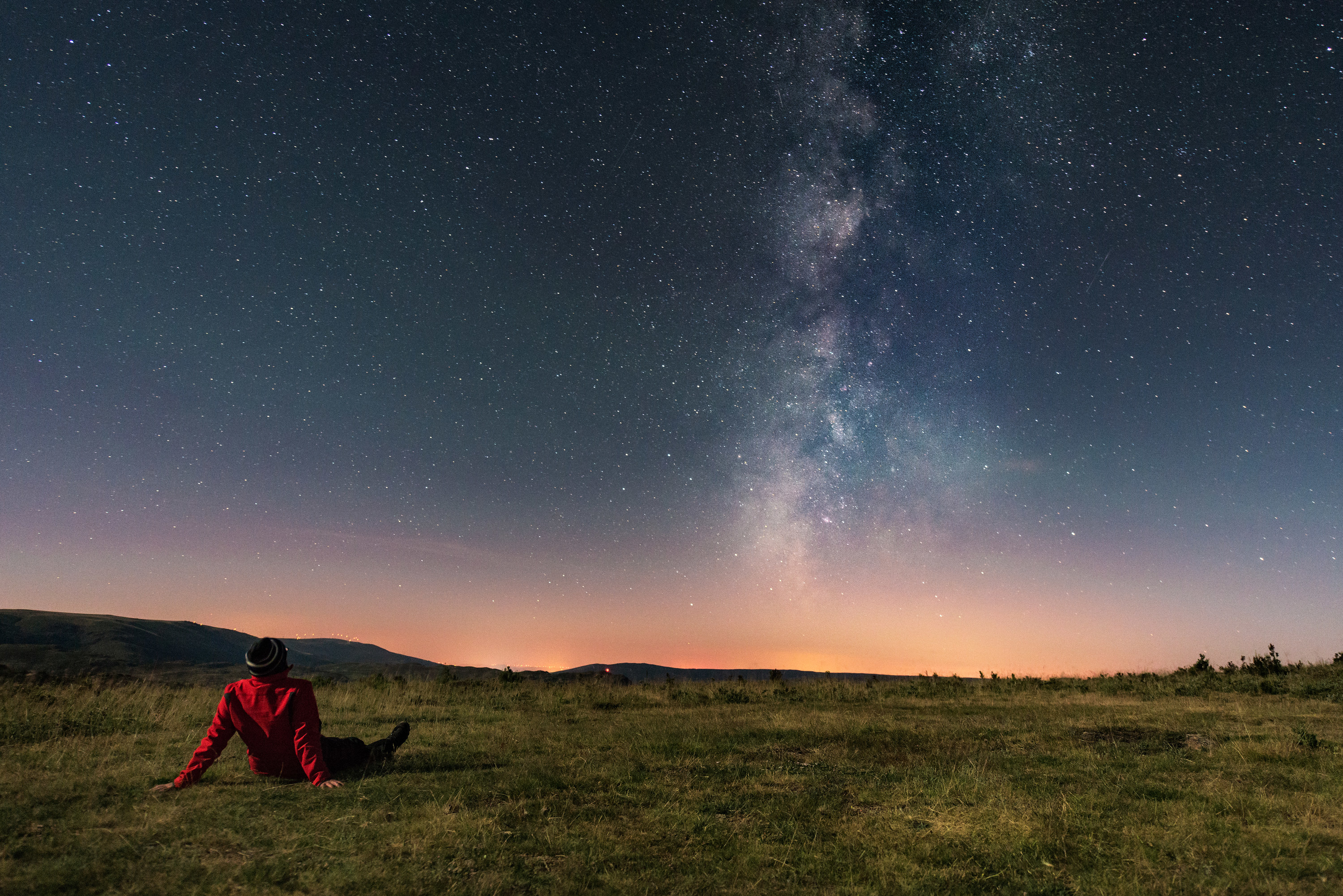 A person out in a field looking at the stars