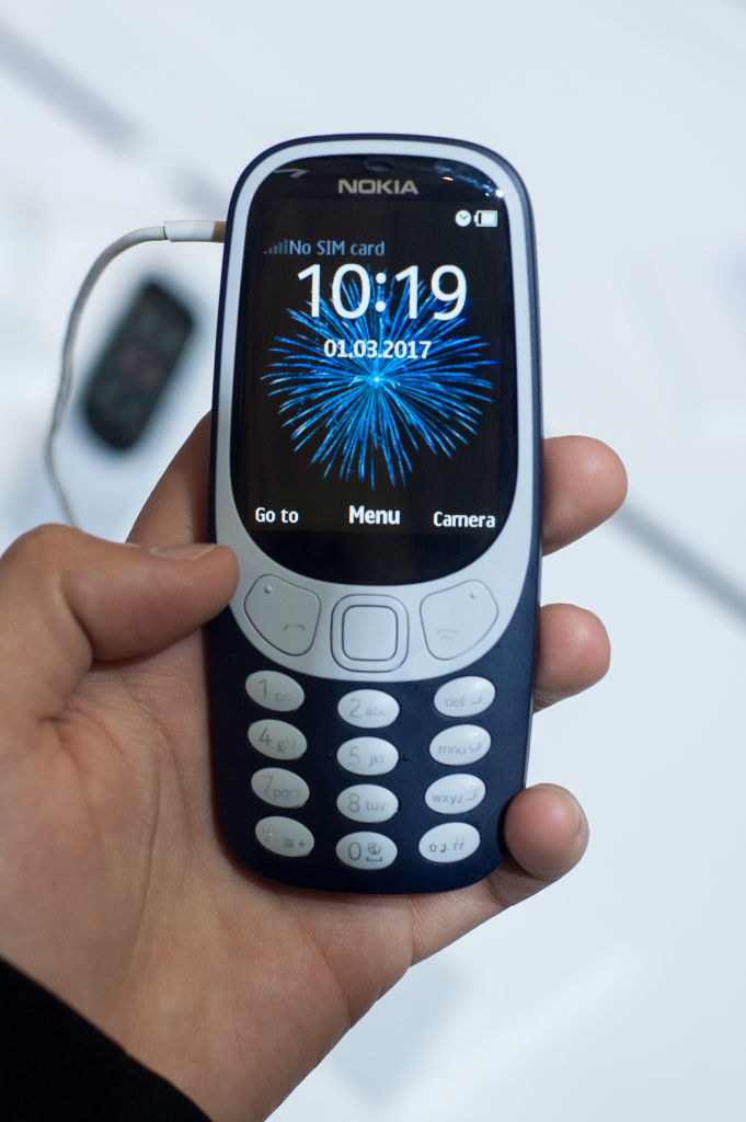 A hand holding a Nokia phone