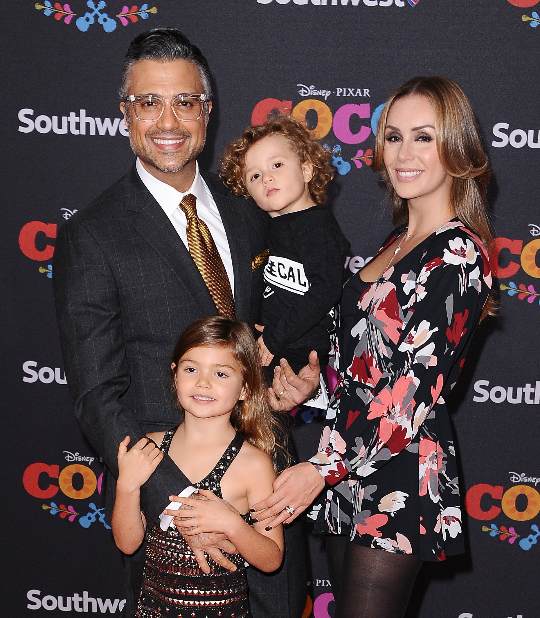 Jaime Camil his wife and two children posing on a red carpet
