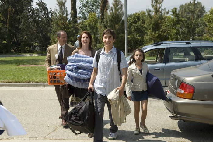 Mark Derwin, Ann Cusack, Justin Long, and Hannah Marks from Accepted, carrying belongings like bags and linen
