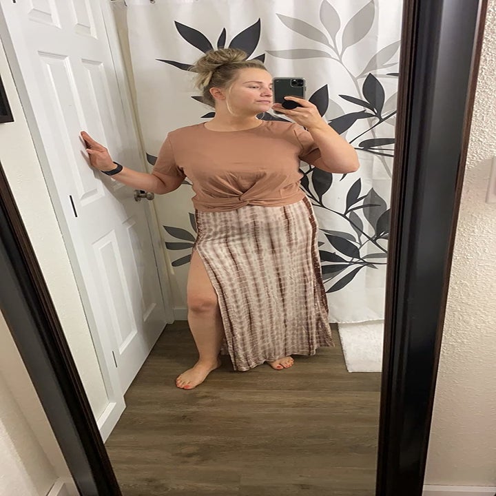 Reviewer wearing the tan and multi-colored skirt