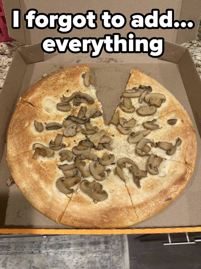 A pizza pie with mushrooms but just dough — no sauce, no cheese