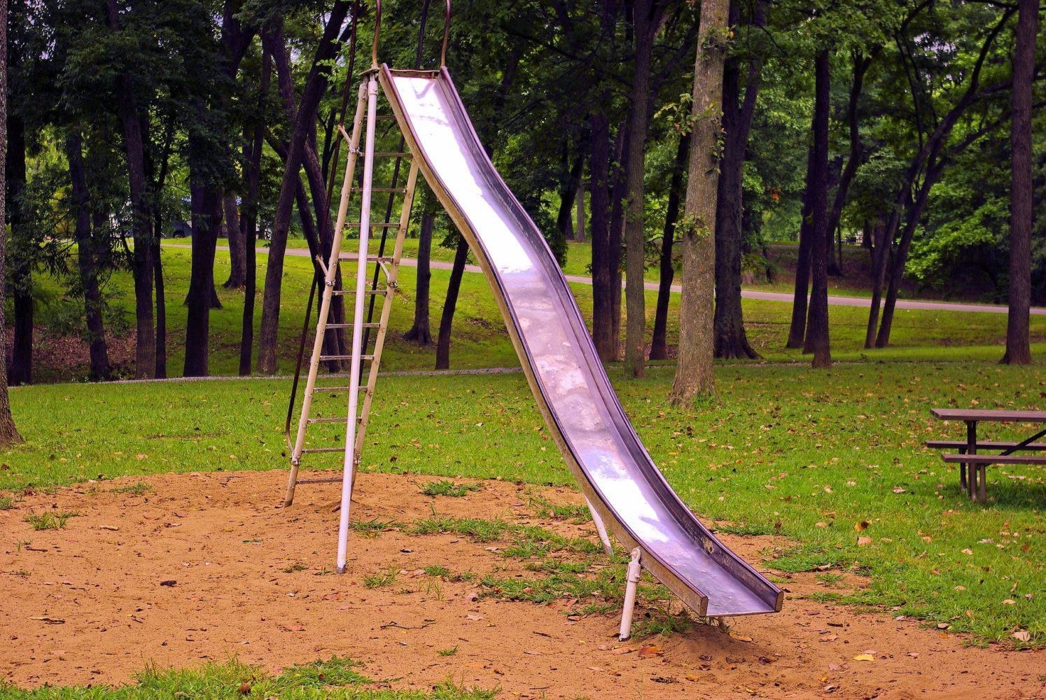 A rickety metal slide at a park