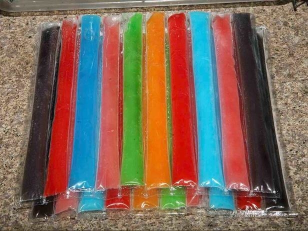 A bundle of colorful ice pops lay on a counter