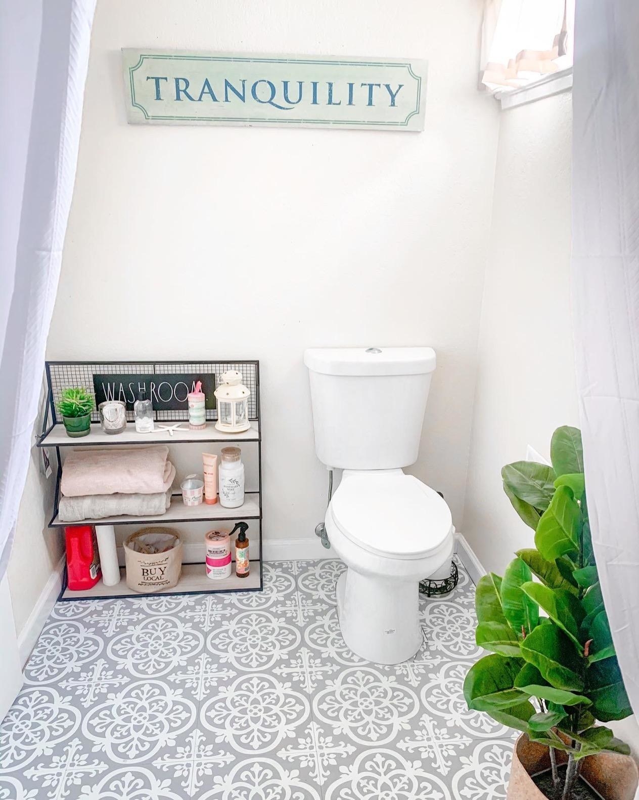 reviewer&#x27;s bathroom with grey and white floral pattern tiles