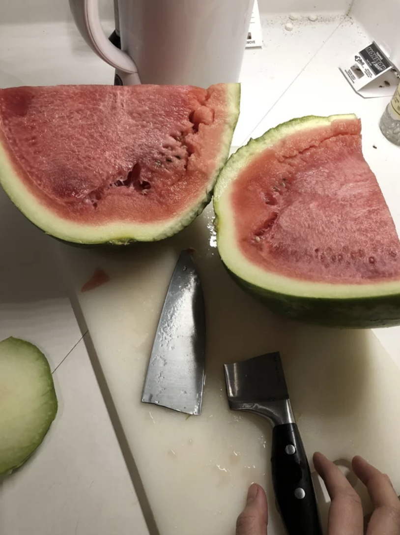 A broken knife next to watermelon