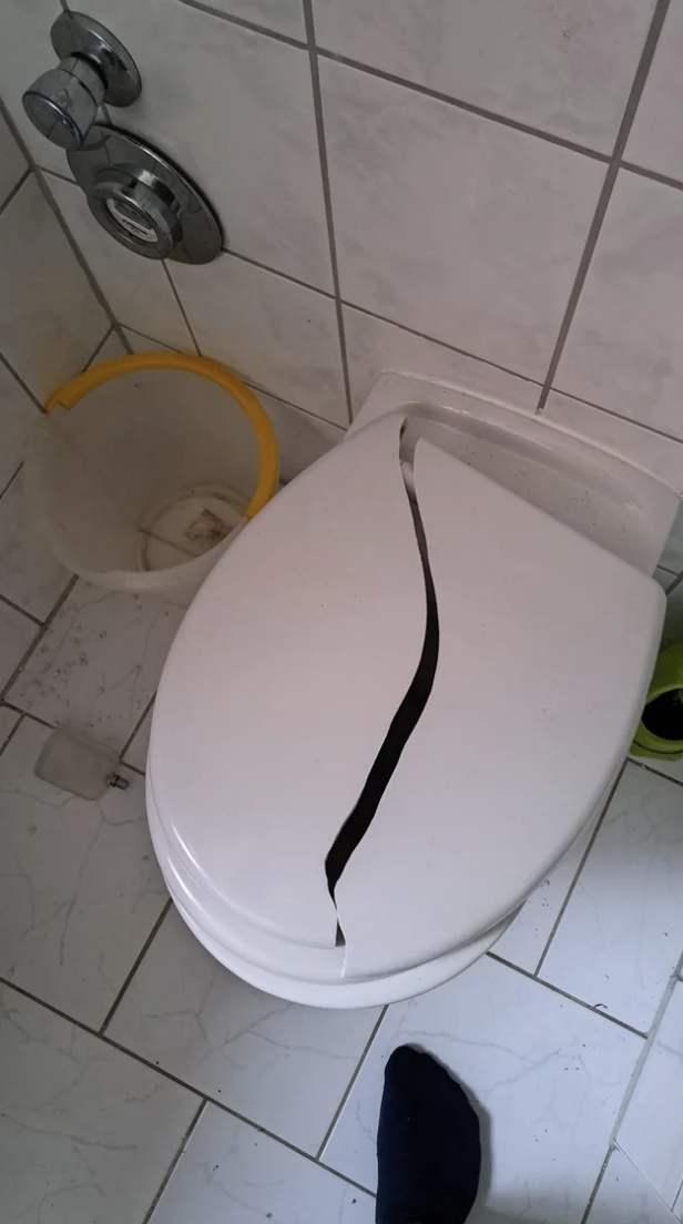A broken toilet cover