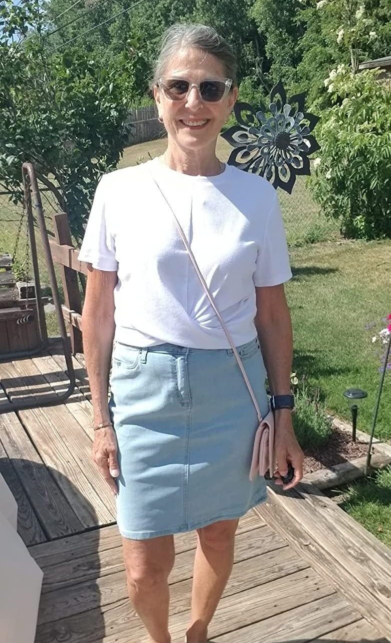 Reviewer in the light wash jean skirt