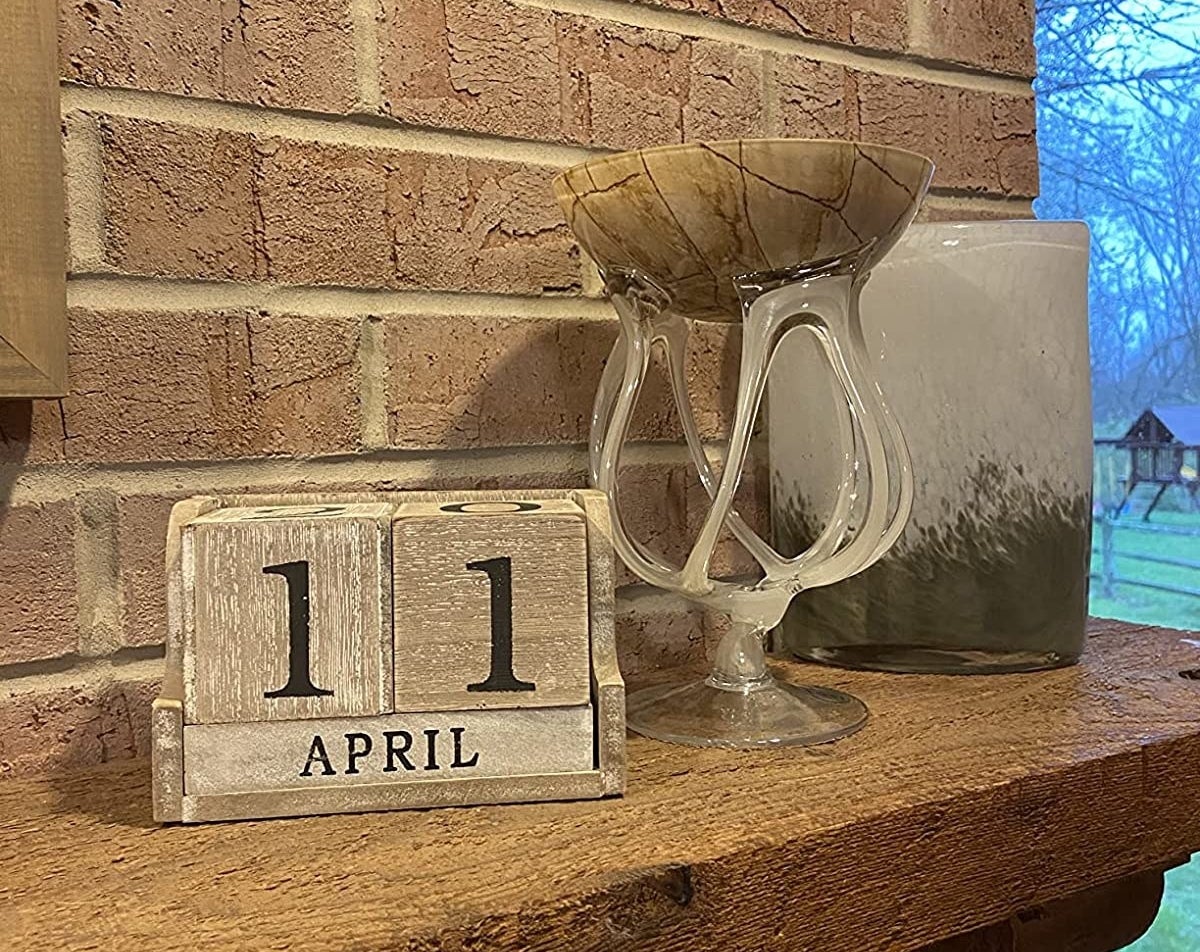 A reviewer&#x27;s photo of the calendar block displayed on their fire place
