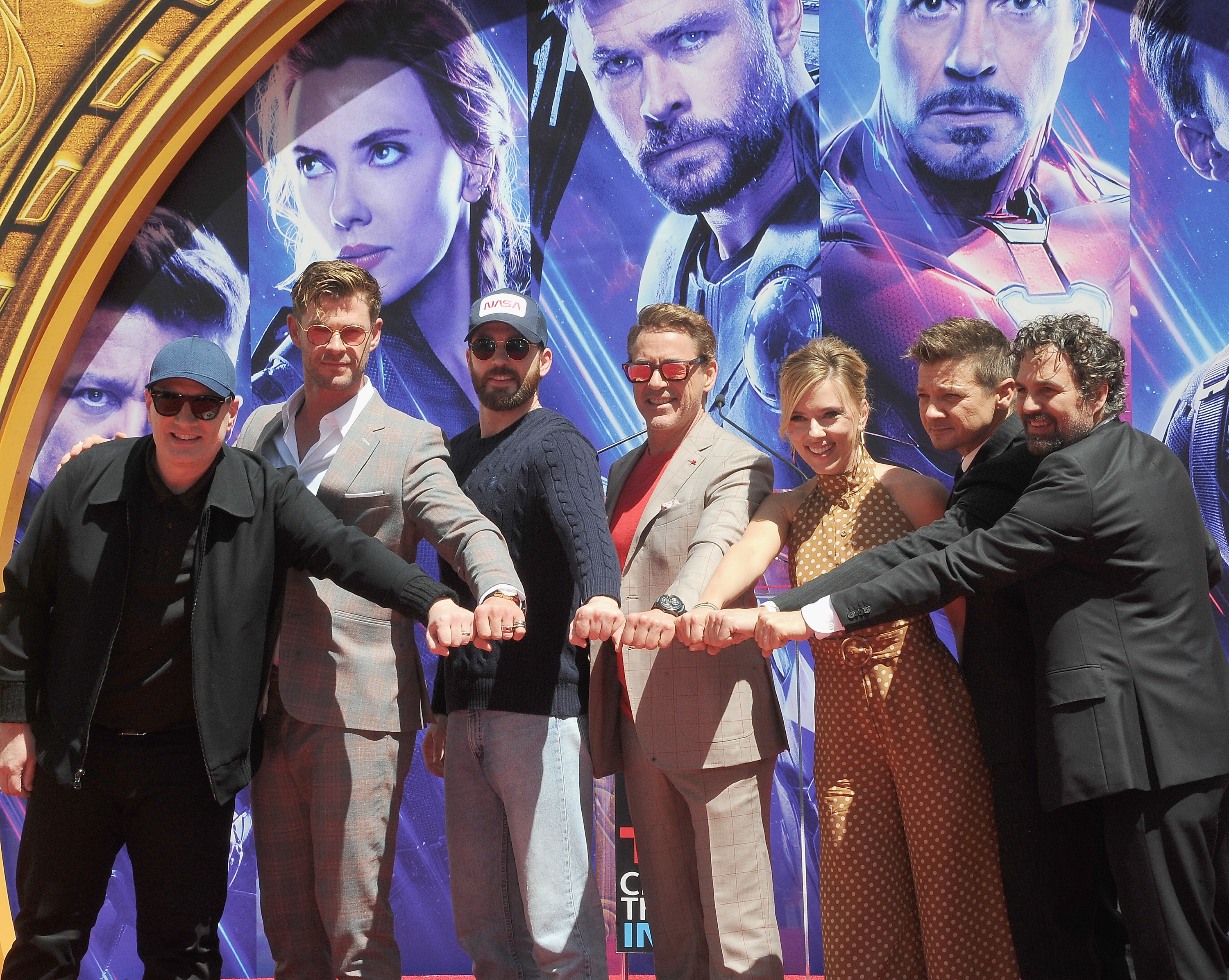 the cast bringing their fists together