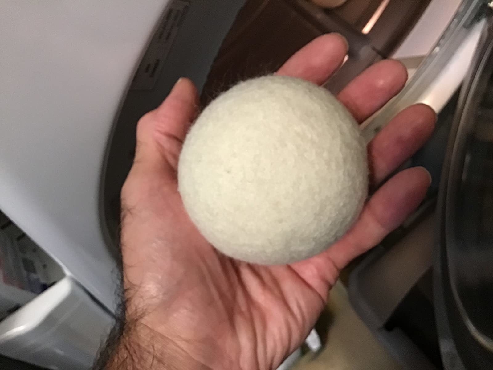 Reviewer holding dryer ball