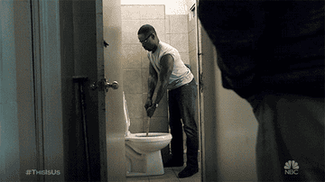 A man plunging a toilet and flushing