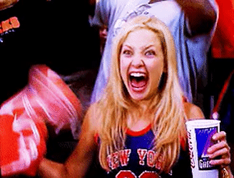 A woman in a jersey cheering for the New York Knicks